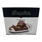 Inspire Coconut Bars, with natural and artificial flavors, packaged in a black box, featuring seven 1.55 oz bars, displayed on a plate with coconut flakes and pieces.