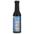 A black glass bottle of organic sauce displays a blue label with nutrition facts and ingredients, positioned upright against a plain background.