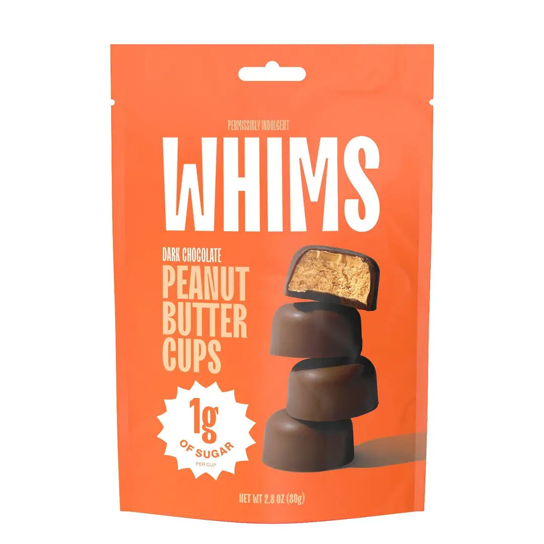 A bright orange package labeled "WHIMS" features stacked dark chocolate peanut butter cups, with one cup showing its creamy filling, and highlights that each contains only 1 gram of sugar.