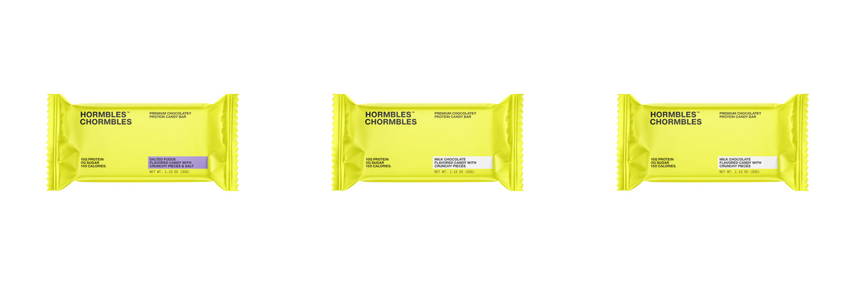 Three brightly colored yellow candy bar wrappers are displayed side by side, each labeled with different flavors: Salted Fudge, Milk Chocolate, and Milk Chocolate with crunchy pieces.