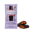 A purple package of Krack'd Snacks Aloha Caramel artisan candy, featuring a chocolate-covered bar with visible almonds and coconut caramel, sits next to a broken piece revealing its interior.