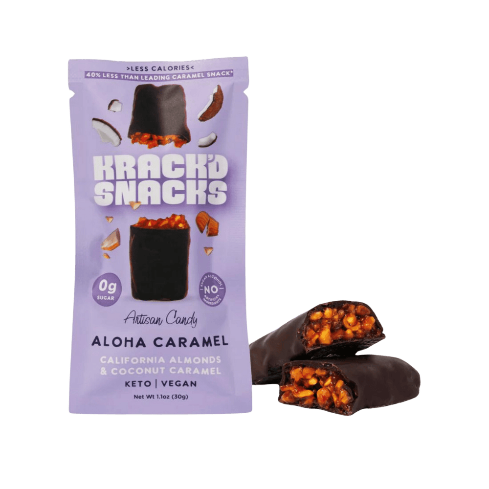 A purple package of Krack'd Snacks Aloha Caramel artisan candy, featuring a chocolate-covered bar with visible almonds and coconut caramel, sits next to a broken piece revealing its interior.
