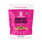 A bright pink package of Lakanto Monkfruit Sweetener with Erythritol, labeled as "Brown" and featuring icons for zero net carbs and keto-friendly, is displayed against a plain background.
