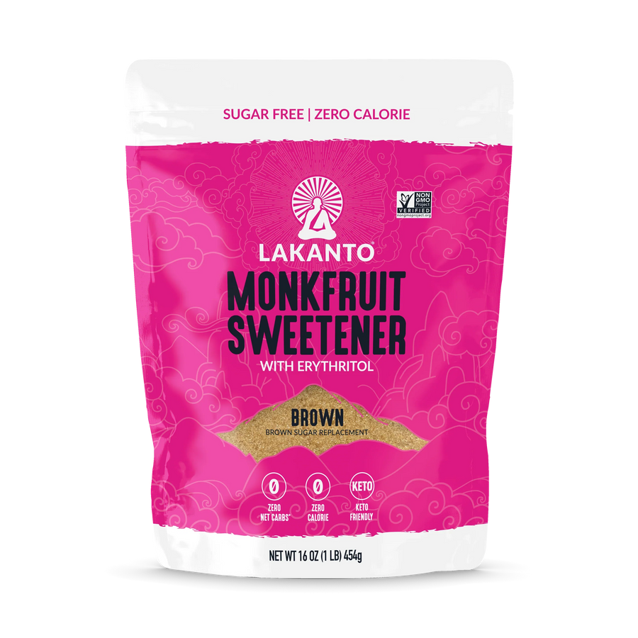 A bright pink package of Lakanto Monkfruit Sweetener with Erythritol, labeled as "Brown" and featuring icons for zero net carbs and keto-friendly, is displayed against a plain background.
