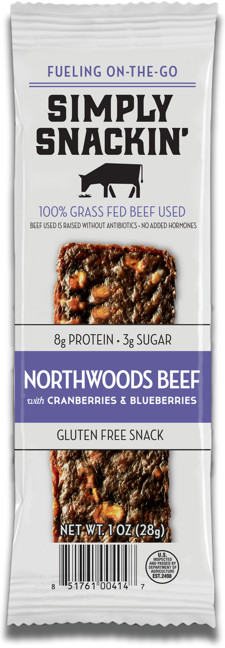 A packaged snack bar labeled "Simply Snackin' Northwoods Beef with Cranberries & Blueberries," highlighting its 100% grass-fed beef, gluten-free status, and nutritional information.