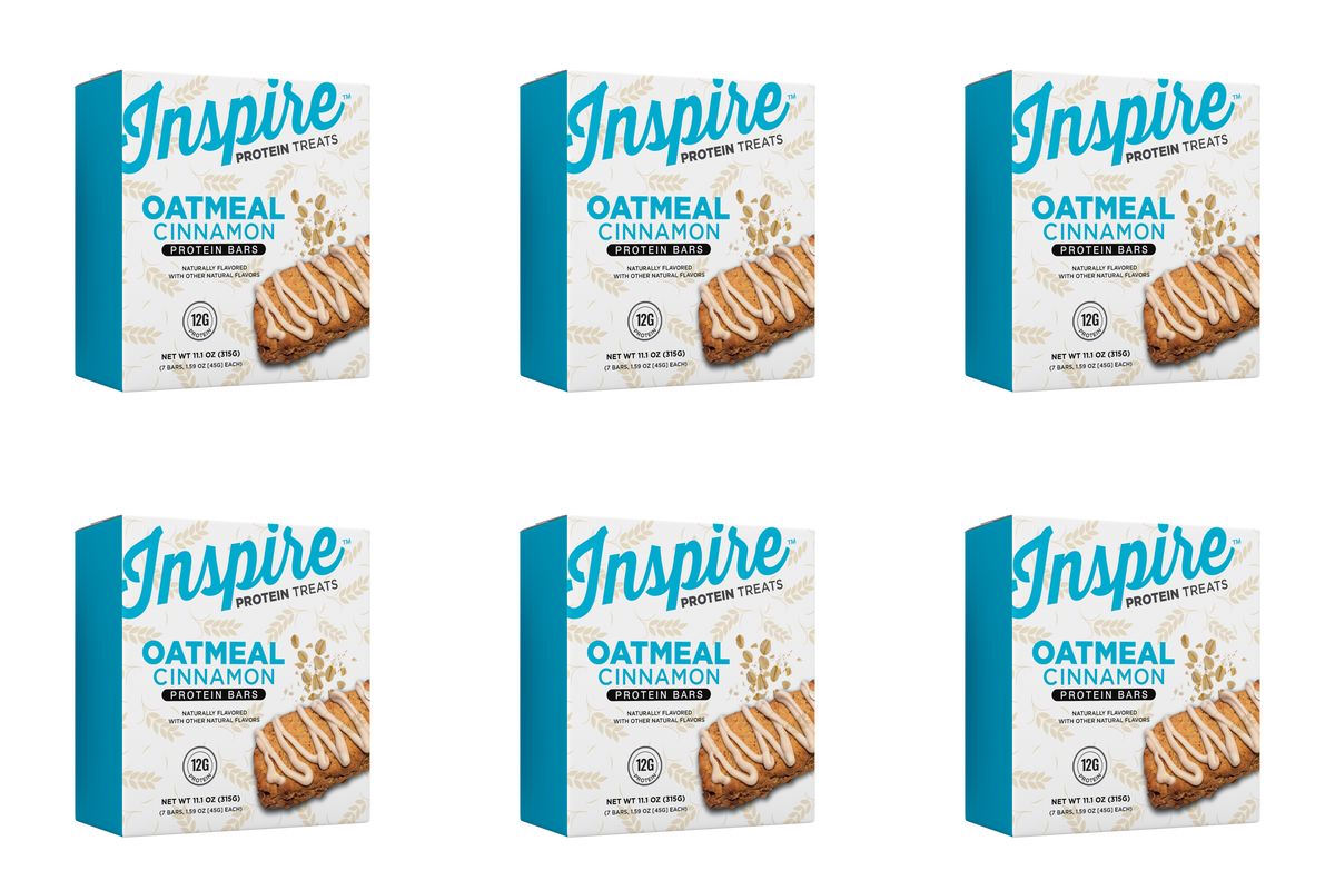 Six boxes of Inspire Oatmeal Cinnamon protein bars are displayed, each featuring a bar drizzled with icing and highlighting 12 grams of protein per serving.