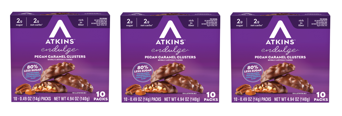 Three boxes of Atkins Endulge Pecan Caramel Clusters are displayed, each featuring chocolate-covered clusters with pecans, highlighting low sugar content and fiber benefits.