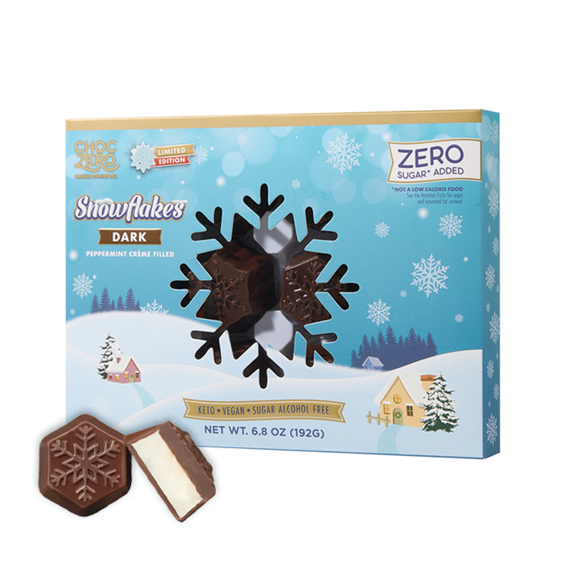 A box of dark chocolate peppermint crème-filled candies shaped like snowflakes is displayed alongside one candy, set against a winter-themed background with snowflakes and a snowy landscape.