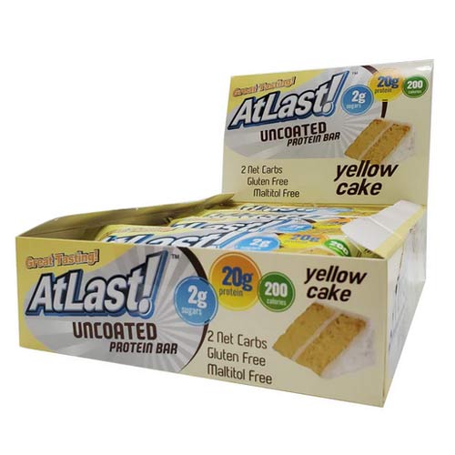 A display box of AtLast! Yellow Cake protein bars.