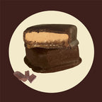 Chocolate-covered nougat pieces, with one cut open to show the center.