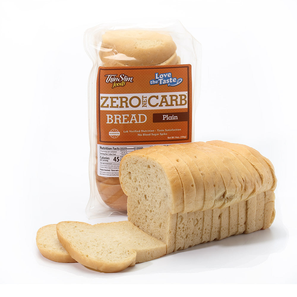 A sliced loaf beside a bag of ThinSlim Foods Zero Net Carb Plain Bread.