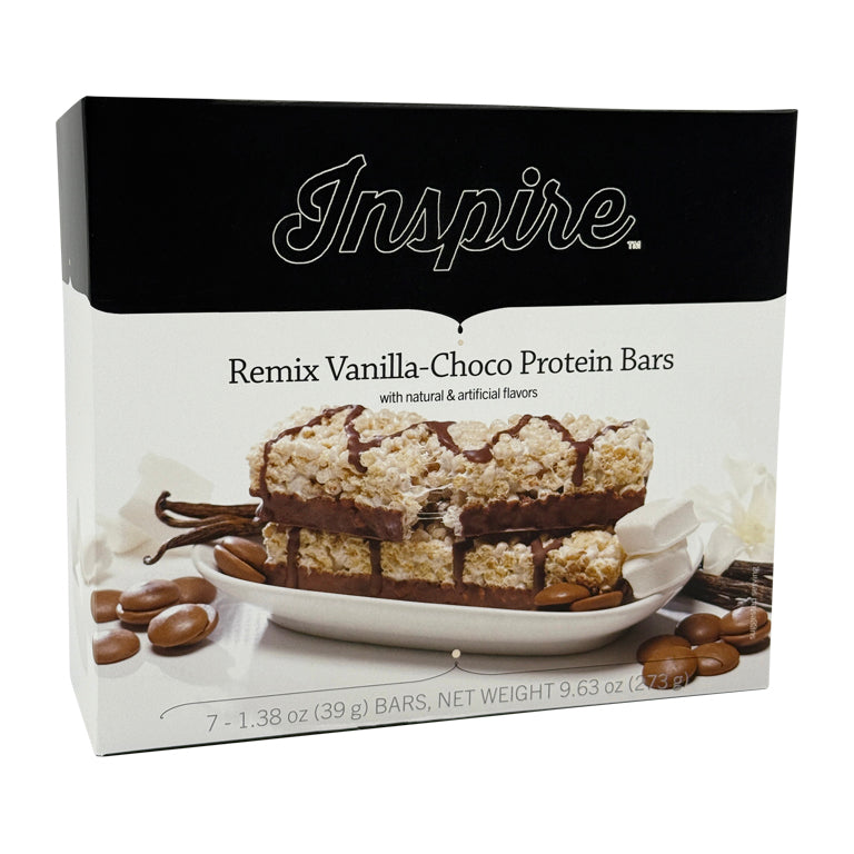A box of Inspire Remix Vanilla-Choco Protein Bars displays the product name and flavor, featuring bars on a plate with chocolate drizzle and cocoa beans beside it.