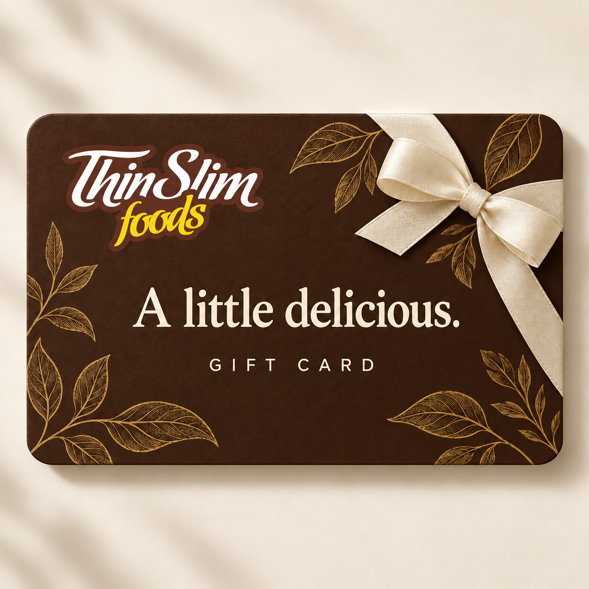 ThinSlim Foods digital gift card in chocolate brown with the ThinSlim Foods script logo, a cream bow, and the words A little delicious.