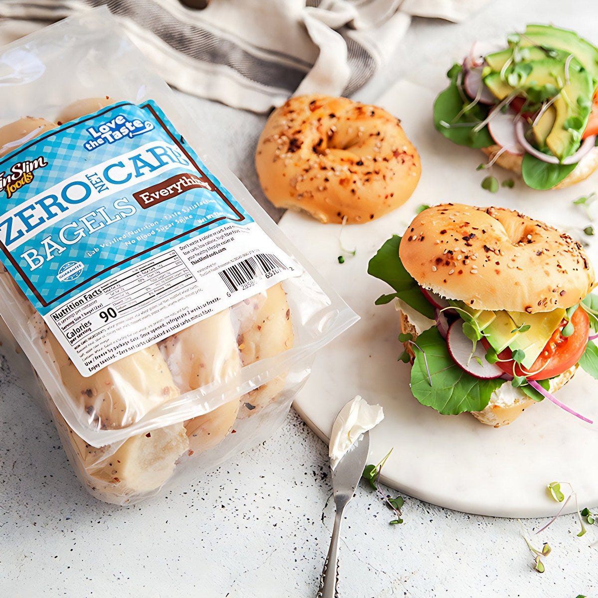 Everything bagel sandwiches with vegetables beside a package of ThinSlim Foods Zero Net Carb Everything Bagels.