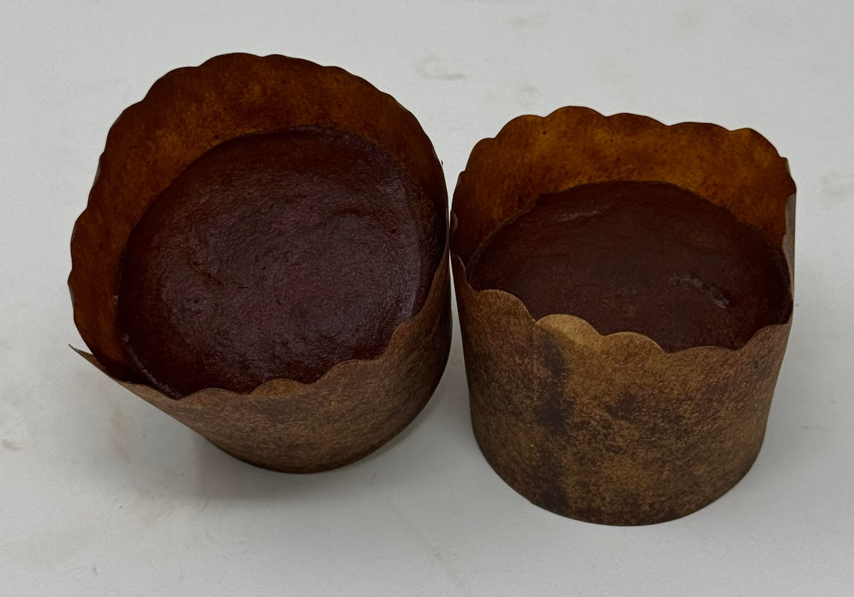 Two ThinSlim Foods chocolate Cloud Cakes in brown paper baking cups.