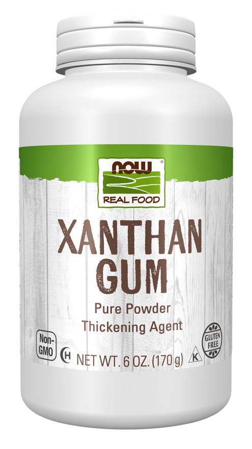 A white container of xanthan gum powder labeled "NOW Real Food," highlighting its use as a thickening agent, with details about being gluten-free and non-GMO.
