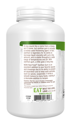 A white bottle of NOW Real Food® Xanthan Gum displays a detailed label highlighting its uses as a thickening agent and cooking ingredient, with cautionary notes about consumption by young children.
